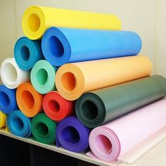 several rolls of colored paper stacked on top of each other