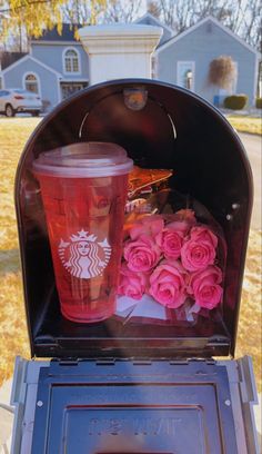 pink roses and starbucks cup in an open mailbox