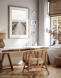 a white desk with a wooden chair next to it in front of a large window