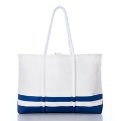 a large white and blue bag with rope handles on the front, sitting on a white surface