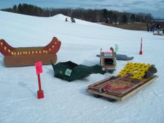 there are many items on the ground in the snow, including a hot dog and corn dogs