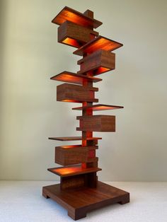 a sculpture made out of wood with lights on it