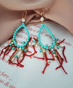 Large Chandelier Earrings made of; - Turquoise Paste stones (4 mm), light blue color; - Freshwater Pearls (4 mm), white color; - Red Coral branches; - Brass chains; - Gold plated 925 Sterling Silver hooks. Lenght : 10 cm / 3,94 inches * SHIPPING * Your order will be shipped within 1-3 business days from your purchase. You can choose between 2 shipping methods: STANDARD MAIL (NOT TRACEABLE) It is a cheap and fast shipping method, but NOT TRACEABLE. Chapeau Atelier is not responsible for any posta Elegant Turquoise Chandelier Earrings With Round Beads, Elegant Turquoise Chandelier Earrings, Blue Gemstone Chandelier Earrings For Gifts, Handmade Turquoise Chandelier Earrings, Turquoise Dangle Chandelier Earrings As Gift, Elegant Handmade Turquoise Chandelier Earrings, Coral Jewelry With Dangling Beads For Gift, Turquoise Teardrop Chandelier Earrings As Gift, Light Blue Earrings With Dangling Beads As Gift