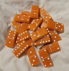 a pile of orange and white dice laying on top of each other