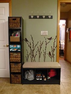 there is a coat rack with shoes on it in the entryway to a house