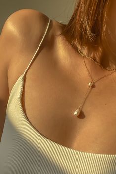 Warm glow on our Elle lariat necklace featuring gold filled chain with freshwater pearls — can wear it in the shower? Check! Chic Long Drop Necklaces For Gifts, Pearl Backdrop Necklace For Parties, Party Pearl Backdrop Necklace, Elegant Pearl Charm Dangle Lariat Necklace, Elegant Pearl Charm Lariat Necklace With Dangle, Elegant Lariat Necklace With Pearl Charm Dangle, Adjustable Lariat Necklace With Pearl Drop, Pearl Lariat Necklace With Single Strand, Chic Pearl Drop Chain Necklace As Gift