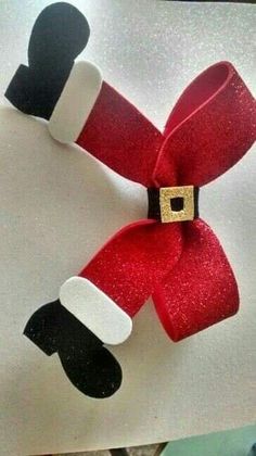 a paper santa clause is hanging on a piece of white paper with black and red trim