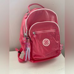 Color: Lively Pink Sold Out Features 56% Recycled Nylon, 44% Nylon Dimensions: 10"L X 13.75"H X 5.75"D Weight: 1.10 Lbs Volume: 14l Adjustable, Padded Backpack Straps Tablet Sleeve Zip-Front Pocket Contains: 2 Pen Sleeves, Cell Phone Pocket, And Slip Pocket Water Bottle Pockets Top Carry Handle Top Zip Pocket Barbie Keychain Description Item# K|7743 Our Most Iconic Styles Just Got A Stunning, Malibu Makeover. Our Signature Crinkle Nylon With A Smooth, Lacquered Coating Gives This Backpack An Ext Barbie Keychain, Real Doll, Tablet Sleeve, Pink Backpack, Barbie Collection, Pocket Top, Backpack Straps, White Trim, Kids Accessories