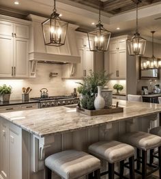 a large kitchen with an island in the middle and four stools at the end