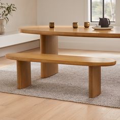 a wooden table with two benches in front of it and a potted plant next to it