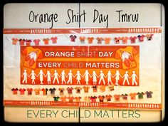 an orange shirt day poster with children's clothes hanging on the wall behind it