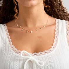 Tiny freshwater pearls adorn this dainty gold filled chain. They are tiered in a 3-2-1 count to create a layering effect. These pearls are tiny and off round. They are freshwater pearls so slight differences are to be expected. - Tiny 2-3mm roundish freshwater pearls- 14K Gold filled chain and clasp Delicate 14k Gold Filled Charm Necklaces With Pearl Pendant, Delicate 14k Gold-filled Charm Necklace With Pearl Pendant, Delicate 14k Gold Filled Pearl Drop Necklace, Delicate Pearl Pendant Charm Necklace, Delicate Adjustable 14k Gold Filled Pearl Necklace, Adjustable Delicate 14k Gold Filled Pearl Necklace, Adjustable Delicate 14k Gold-filled Pearl Necklace, Dainty Pearl Charm Necklace With Pearl Chain, Delicate 14k Gold Filled Necklaces With Pearl Charm