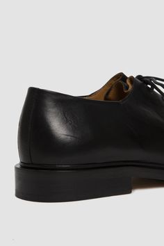 A black smooth leather oxford with criss-crossed detailing, a waxed lace-up front fastening, a round toe with tonal stitch detailing and a chunky leather sole. The Edouard is a minimalist urban shoe, inspired by vagabond lifestyle. With its thick padded sole, it is both comfortable and long wearing. Jacques Solovière Paris's lace-up oxfords are handcrafted in their historic factory. Leather Lace-up Derby Shoes, Classic Oxfords For Office With Stitched Sole, Classic Office Oxfords With Stitched Sole, Leather Cap Toe Oxford With Rubber Sole, Black Lace-up Oxfords With Leather Lining, Leather Oxford Shoes With Rubber Sole For Derby, Leather Oxford Shoes With Almond Toe For Derby, Classic Goodyear Welted Lace-up Shoes For Work, Luxury Lace-up Oxfords For Work