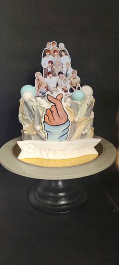 a cake decorated with an image of a hand holding a baby's thumb on it