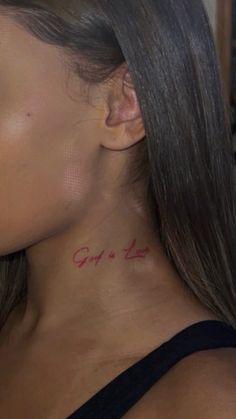 a woman with a tattoo on her neck that says opi's life written in red ink