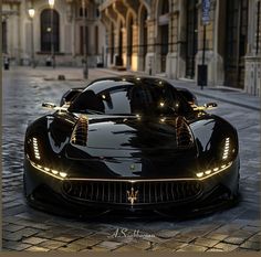 a black sports car parked in front of a tall building on a cobblestone street