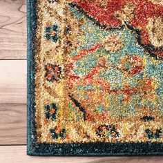 an area rug on the floor with wood floors in the background and a blue border around it