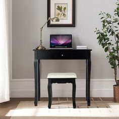 a small desk with a laptop on it