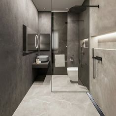 a modern bathroom with marble walls and flooring, including a walk in shower area