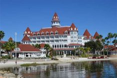 a large white and red building sitting on top of a beach