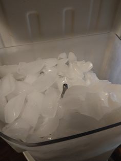 a bowl filled with ice sitting on top of a table