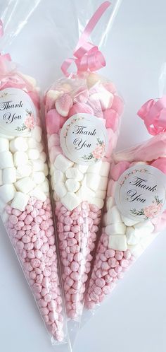 pink and white candies wrapped in cellophane with thank you tags on them