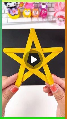 a person holding up a yellow paper star