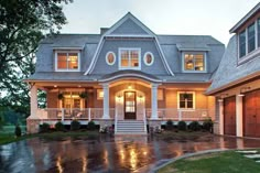 a large house with lots of windows on it's front and side porchs