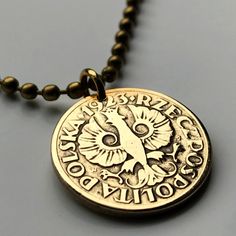 a necklace with a medallion on it that says, happy holidays and an image of a bird