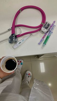 a doctor's stethoscope, cup of coffee and other medical supplies