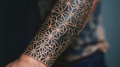 Detailed geometric arm tattoo design with interlinked patterns and shading on a dark blue background, showcasing intricate body art. Geometric Tattoo Design, Next Tattoo, Cover Design