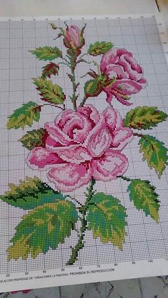 a cross stitch rose pattern on the floor