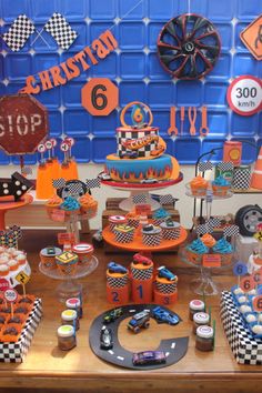 a table topped with lots of cakes and cupcakes