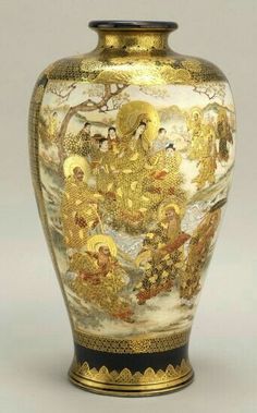 an ornate vase with gold decorations on it