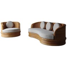 two wooden chairs with white cushions and pillows on the back one is shaped like a boat