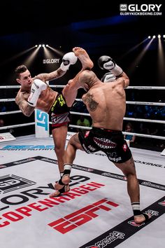 two men in the middle of a boxing ring