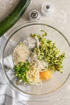 ingredients to make zucchini salad in a glass bowl