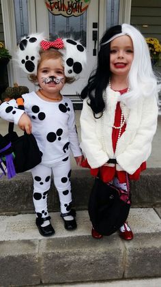 two children dressed up in halloween costumes standing on the front steps with their faces painted