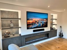 a flat screen tv mounted on the wall in a living room