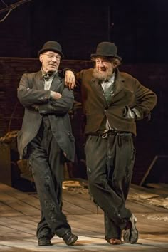 two men standing next to each other on a stage