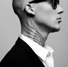 a man with a bald head and sunglasses on his face, has a tattoo on his neck