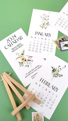 four calendars with wooden clothes pins on top of them and some other items to make it