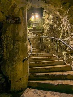 the stairs lead up to an underground tunnel