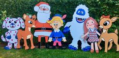 a group of cartoon characters standing next to each other in front of bushes and trees