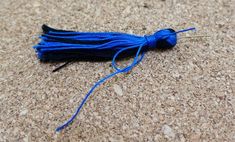 a blue tassel is laying on the ground