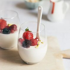 two glasses filled with yogurt and berries