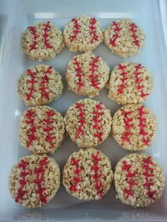 twelve cookies with red sprinkles in a plastic container