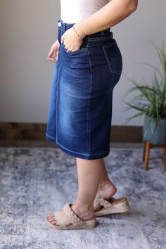 Elevate your wardrobe with the Mia Dark Wash Solid Midi Skirt. This classy and chic staple skirt is perfect for every closet. Its solid dark wash and white stitching details add a touch of chic to any outfit. A must-have for any fashion lover. How This Modest Midi Skirt Fits: Modeled of typical Medium bottom wearing the Medium. See approximate flat lay across measurements (waist, hips) below: Flat Across Measurements in Inches Size: Waist Across Hips Across Length X-Small Small 15 17.5 25 Medium Modest Denim Skirts, Skirt Outfits Summer, Casual Mom Style, Solid Skirt, Modest Skirts, Skirt Fits, Curvy Dress, Summer Skirts, Mom Style