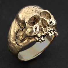 "Custom made to order The ULTIMATE SKULL RING - one big hunk of GOLD! I designed this classic to have a lower profile than most to make it more \"pocket friendly\" Unbelievable detail. Heirloom quality Hand carved in wax by me in my studio then cast (by me) in solid 14K gold. The inside is mirror polished for comfort. Extremely comfortable to wear. 100% SOLID 14K yellow (or 14K white) gold Skull Ring - no backside hollowing. Weighs 33 grams (over 1 ounce) of 14K gold in size 11. Also available i Skeleton Ring, Skull Rings, Metal Skull, Biker Jewelry, Gold Skull, Vintage Skull, Ring Mens, Punk Jewelry, Jack Sparrow