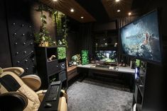 a gaming room with two monitors and a laptop on the desk in front of it